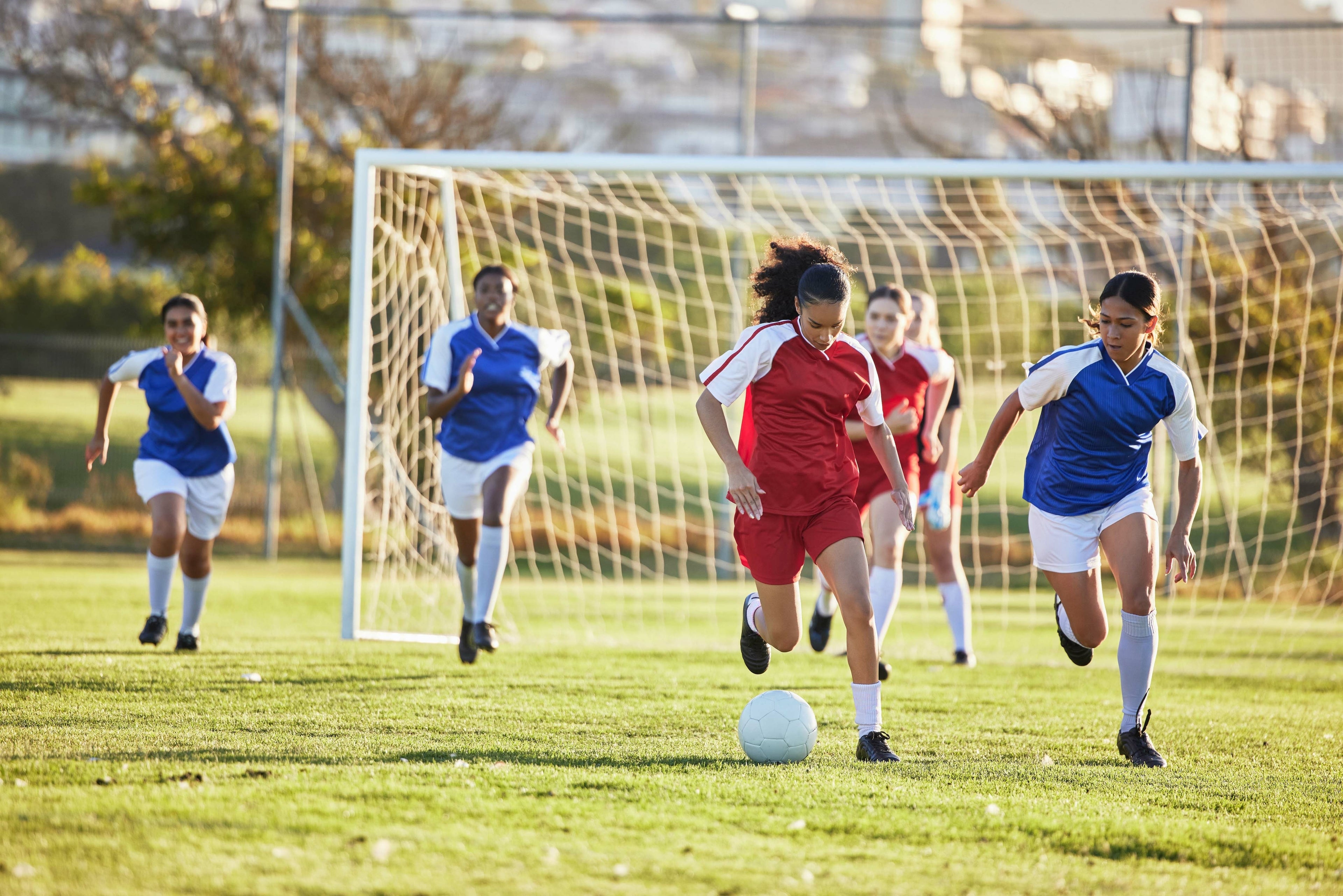 Teen girls playing soccer
