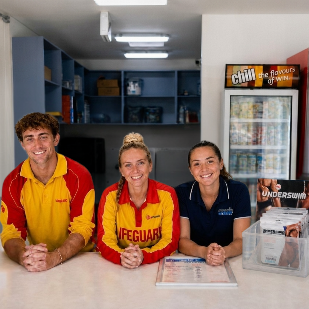 Swim-school reception team beside a compact UnderSwim counter display